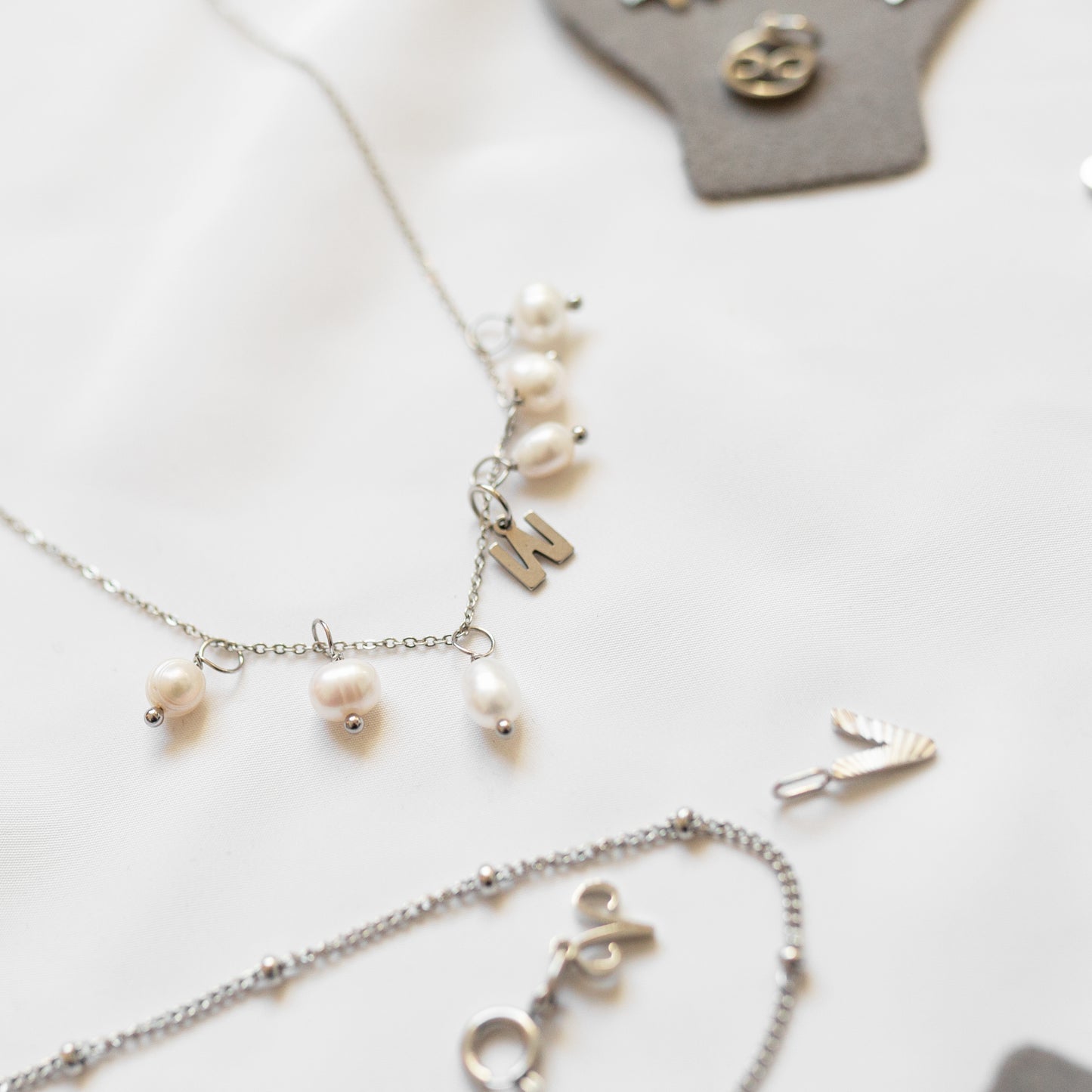 Gold pearl charm
